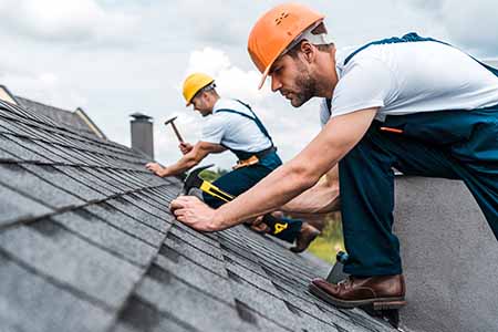 roofers nailing in shingles